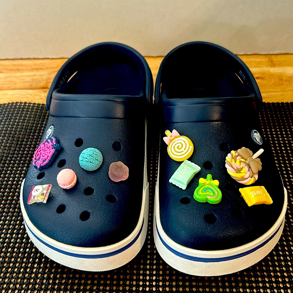 Crocs size 5 Men’s 7 Women’s Navy Blue and White with various jems.